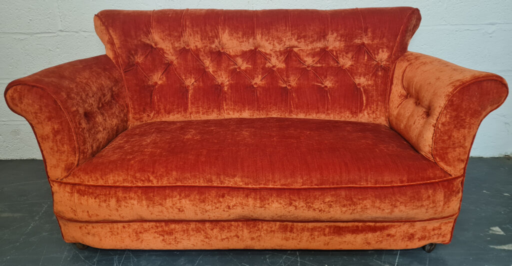 Victorian Deep Buttoned Sofa reupholstered in Ross Fabrics Pastiche Slub Burnt Orange. 